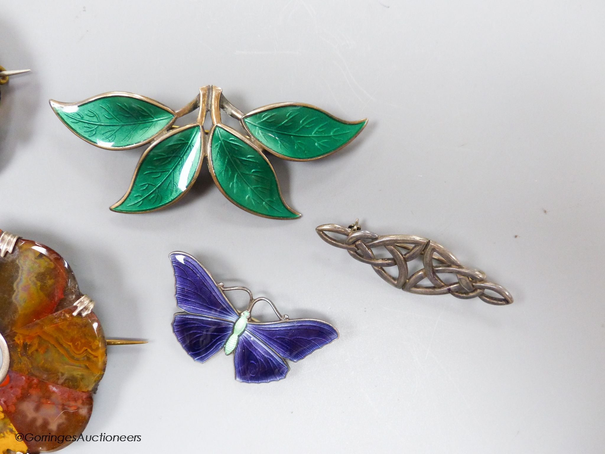 Two sterling and enamel brooches, including butterfly, 37mm, one other white metal brooch and three hardstone set brooches.